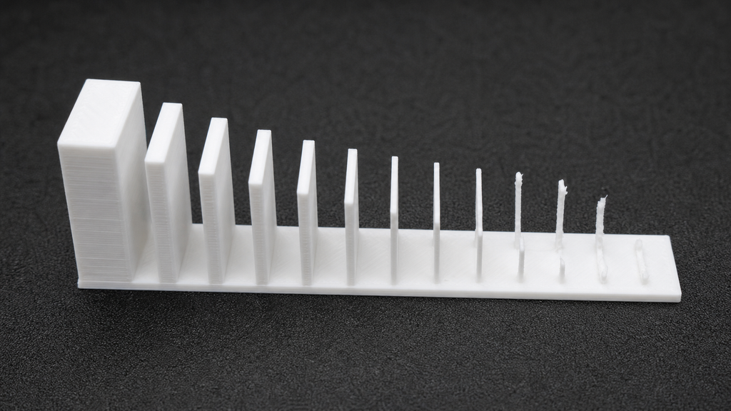 White wall test with a complete thick reference wall and progressively thinner features that print incomplete or break.